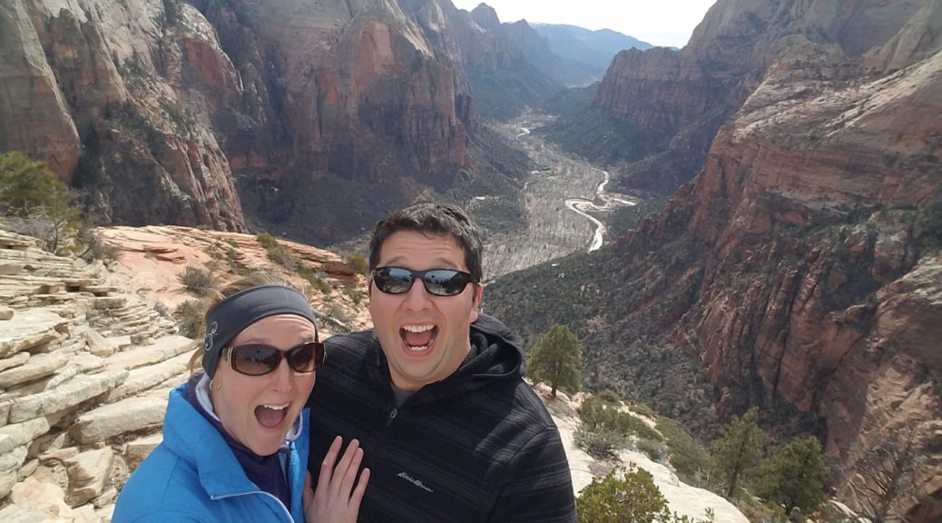April and Tiago at the top of angels landing with looks of shock on their faces